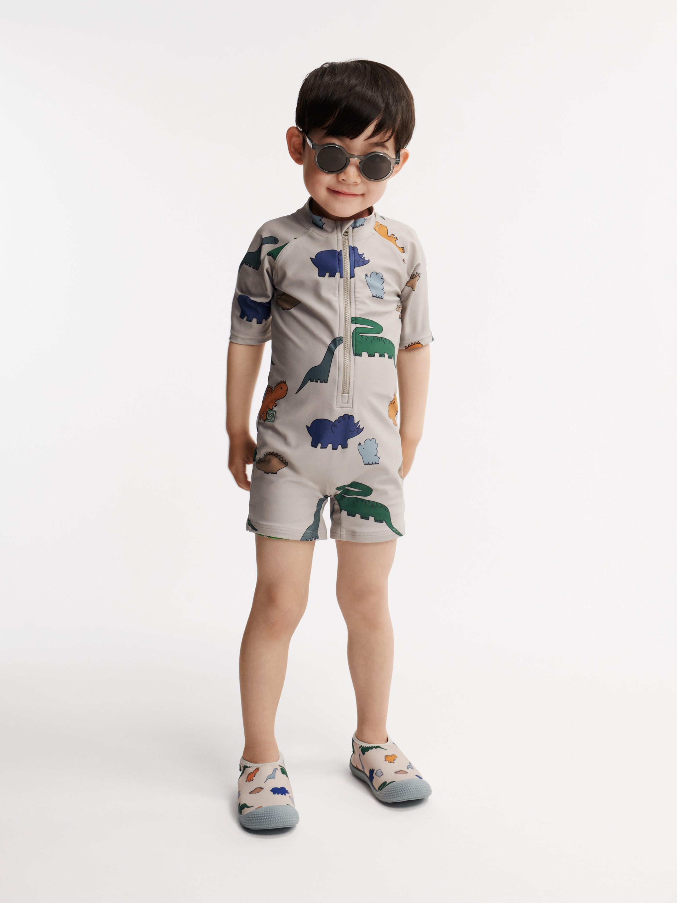 Liewood - kombinezon kąpielowy z krótkim rękawem UV Max Printed dinosaurs mist